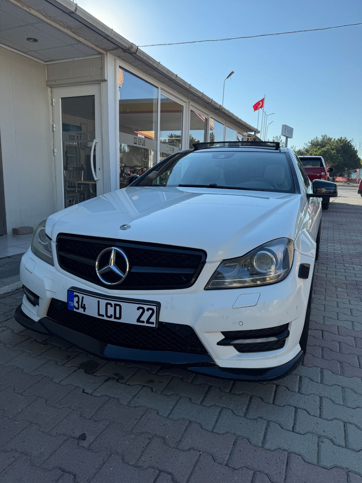 Front-facing car photo shown with the Flying Entrance reference