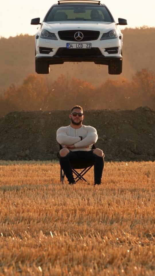 Flying Entrance scene showing a car in the air behind a seated person